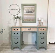 a desk with drawers and a mirror above it