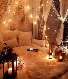 a living room filled with lots of pillows and lights