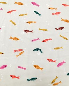 an image of colorful fish on white fabric