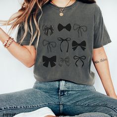 *Please note, holiday shipping times may be longer than normal. Please allow at least 7 days for shipping*  cute black bow Halloween tee. If wanting an oversized look, please size up 1 to 2 sizes from your original size. Please check material details.  RETURNS OR EXCHANGES All of our shirts are custom printed to order, made just for you, so we do not accept returns or exchanges due to color or fit/size. If there are any issues with the shirt, please message us and we will replace it ASAP. WASHIN Casual Black Top With Bow, Black Vintage Top Gift, Vintage Black Top As Gift, Vintage Black Top Gift, Gift Retro Black T-shirt, Bow Tie Hair, Dark Coquette, Check Material, Tie Hair