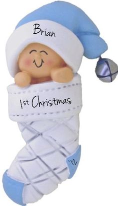 a baby's first christmas ornament with a blue hat and white diaper