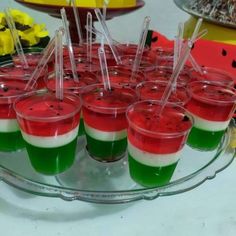 there are many desserts on the table with toothpicks stuck in them to look like watermelon