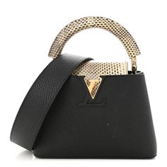 This authentic LOUIS VUITTON Taurillon Ayers Mini Capucines in Black. This beautiful bag is composed of taurillon leather in black with luxurious watersnake skin accents. The handbag features a single rolled snakeskin leather reinforced top handle, black leather shoulder strap, gold hardware, and a snakeskin leather crossover flap that inserts behind theprominent gold and black LV logo. This opens to reveal a partitioned black leather interior with a patch pocket. Lv Logo, Louis Vuitton Capucines, Louis Vuitton Empreinte, Louis Vuitton Shoulder Bag, Black Backpack, Beautiful Bags, Leather Interior, Bag Straps, Authentic Louis Vuitton