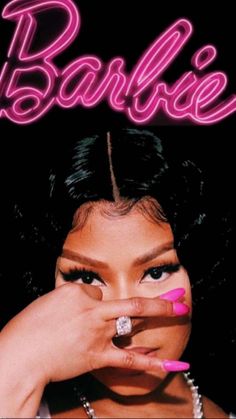 a woman with pink nail polish holding her finger up to her mouth and the words barbieie on it