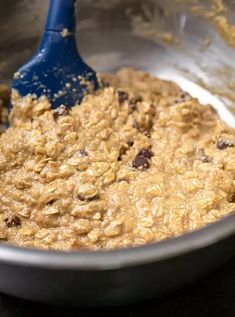 a metal bowl filled with oatmeal and chocolate chips