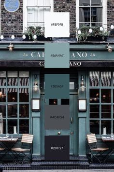 the exterior of a restaurant painted in shades of gray, green and blue with chairs outside