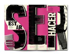 an open book with black and pink typograms on the cover, which reads est