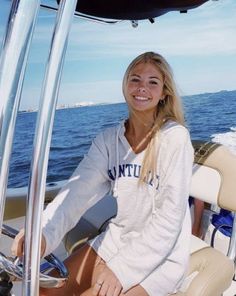 a woman sitting on the back of a boat