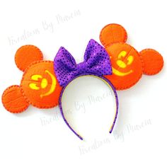 an orange and purple mickey mouse ears headband