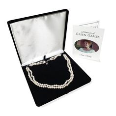 Pre-order until new inventory comes in. This item will not ship until January. Inspired by the string of pearls that Matthew gave Anne before the famous concert at the "White Sands Hotel" in Anne of Green Gables, this exquisitely designed necklace features two intertwined strands of genuine cultured freshwater pearls. Each necklace comes in a jewelry gift box and is accompanied by a certificate of authenticity. Product Details: Necklace measures 46 cm long Pearls 5mm each Made of genuine culture Classic Double Strand Necklace For Gift, Classic Pearl Necklace For Mother's Day Gift, Elegant Green Pearl Necklace For Gift, Formal Double Strand Pearl Necklace With Pendant, Gift Double Strand Pearl Necklace With Charm, Double Strand Pearl Necklace With Charm As Gift, Classic Pearl Necklace For Anniversary And Mother's Day, Formal Pearl Chain Jewelry For Mother's Day, Akoya Pearl Double Strand Necklace As A Gift