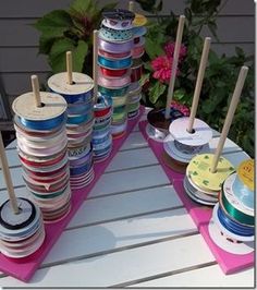 there are many different types of tins on the table with flowers in the background