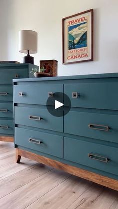 a blue dresser in a room with wood floors