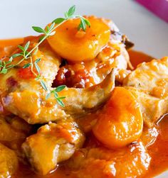 a white plate topped with meat covered in gravy