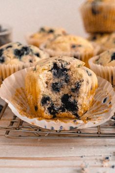 blueberry muffins sitting on top of a cooling rack