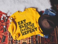 Eat Sleep Football Repeat Sweatshirt You'll receive a football sweatshirt with a vintage feel eat sleep football repeat design. This football sweatshirt can make a vintage feel mom outfit, turkey day sweatshirt, football season sweatshirt, touchdown sweatshirt, Mother's Day sweatshirt, unique game day sweater, mom graphic sweatshirt, school football sweatshirt, cottagecore sweater, college football crewneck sweatshirt, football team sweater, fall football sweatshirt, Mother's Day gift for her an Trick Or Treat Costume, Spooky Sweatshirt, Thanksgiving Sweater, Skeleton Sweatshirt, Witch Sweatshirt, Halloween Party Outfits, Dancing Skeleton, Coffee Sweatshirt, Halloween Sweater