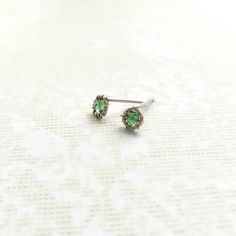 Adorn your ears with the elegance of natural tsavorite garnet. These stud earrings feature high-quality, multi-faceted rondelle beads, each measuring 3 mm, elegantly wire-wrapped in choice of 925 sterling silver or 14K gold filled. The chic circular design has a diameter of 6 mm. For a secure fit, the posts come with silicone backings. Presented in a small gift box, these earrings are ready for gifting.  *Gold Filled: A thicker layer of gold is mechanically bonded to a base metal (usually brass) Silver Earrings With Prong Setting For May Birthstone, Tsavorite Earrings Gift For May Birthstone, Tsavorite Earrings For May Birthstone Gift, Classic Sterling Silver May Birthstone Earrings, Green Birthstone Earrings For Everyday, Dainty Green Sterling Silver Earrings, Tsavorite Gemstone Earrings For May Birthstone, Peridot Earrings For May Birthstone Gift, Elegant Peridot Birthstone Earrings