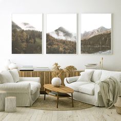 a living room with two paintings on the wall and a coffee table in front of it