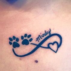 a dog's paw and heart tattoo with the word muddy written on it in cursive writing