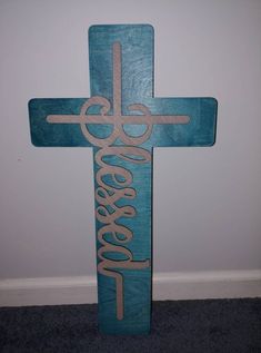 a wooden cross with the word jesus on it