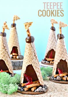 three miniature teepee cookies are sitting on the ground