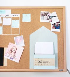 a cork board with photos, memos and magnets on it