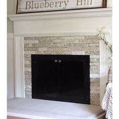 a fireplace with a sign above it that says blueberry hill