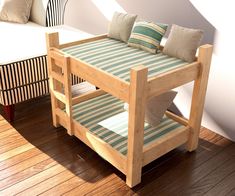 a wooden bed frame sitting on top of a hard wood floor next to a white couch