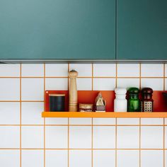 the shelves in the kitchen are filled with spices