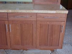 a wooden cabinet with marble top in a kitchen