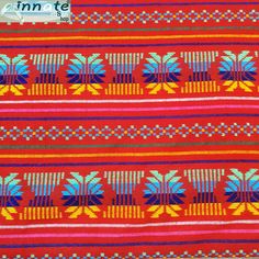 a red and blue striped fabric with palm trees on the side, in different colors