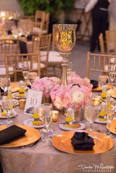 the centerpieces on this table are adorned with crystal candlesticks and flowers