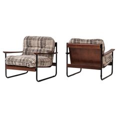 a pair of chairs with plaid upholstered fabric and metal frame, one in the shape of a reclining chair