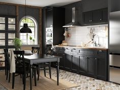 a kitchen with black cabinets and white tiles on the floor is pictured in this image