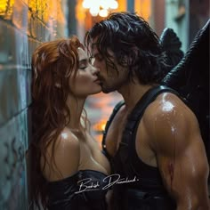 a man and woman in wet clothes kissing each other while standing next to a wall