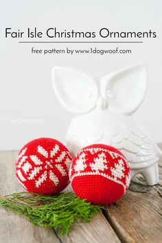 two knitted christmas ornaments sitting on top of a wooden table