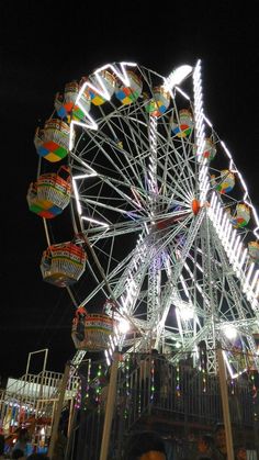 a ferris wheel lit up at night time