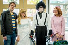 three people dressed up in costumes standing next to each other