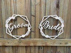 two white metal signs that say groom and bride