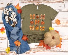 autumn girly shirt,autumn sweatshirt,bow shirt,fall shirts,cute pumpkin bow,fall bow,fall pumpkin bow,fall pumpkin t-shirt,fall sweatshirt,gifts for her,halloween bow,pumpkin season,pumpkin sweatshirts FOR MULTIPLE ORDERS:  1. Look at the pictures carefully. 2. Choose your size and color from the dropdown menu. 3. Add to Cart, then repeat these steps for each shirt you want. This classic unisex jersey short sleeve tee fits like a well-loved favorite. Soft cotton and quality print make users fall in love with it over and over again. These t-shirts have-ribbed knit collars to bolster shaping. The shoulders are tapered for a better fit over time. Dual side seams hold the garment's shape for longer. .: Made with 100% Airlume combed and ring-spun cotton, a lightweight fabric (4.2 oz/yd² (142 g/ Cute Cotton Shirt For Fall, Cute Fall T-shirt For Gift, Fall Short Sleeve Tops For Gifts, Fall Short Sleeve Tops For Gift, Short Sleeve Tops For Fall Gift, Cute Fall Crew Neck Shirt, Cute Crew Neck Fall Shirt, Cute Crew Neck Shirt For Fall, Cotton Tops As Fall Gift