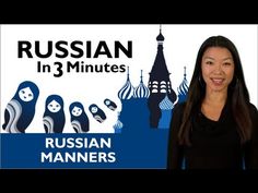 a woman standing in front of a blue and white sign with russian words on it