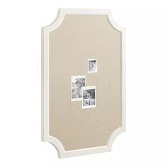 a white frame with four pictures hanging on the front and back of it's sides