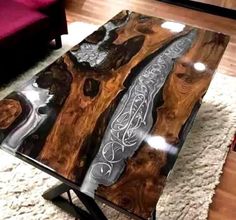 a coffee table made out of wood and glass with an intricate design on the top