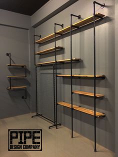 an industrial style shelving unit with wooden shelves