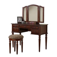 a wooden vanity with mirror and stool