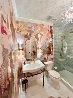 a bathroom with a toilet, sink and shower in it's center wallpaper