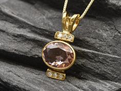 Gold Morganite Pendant set with Created Morganite in a perfect diamond cut & flawless clarity, size 10x8mm with small CZ Diamonds (3 Cts). Gold Oval Pendant design made of Gold Vermeil ☞ thickest 18k Gold Plating on top of Solid 925 Sterling Silver ☞ made to last.Click here for ☞ Matching Ring Click here for ☞ Matching Earrings Details:• Created Morganite in a flawless clarity & CZ Diamonds• Morganite: 10x8mm, 3 Ct, diamond cut• Pendant Height 21mm, Width 10mm• Free Complimentary Chain• 18k Gold Gold Oval Gemstones With Brilliant Cut, Elegant Gold Oval Gemstones, Elegant Oval Gold Gemstones, Luxury Pink Oval Necklace, Fine Jewelry Pink Oval Necklace, Pink Oval Fine Jewelry Necklace, Pink Oval Fine Jewelry Necklaces, Pink Oval Gemstones For Gift, Pink Oval Gemstones For Gifts