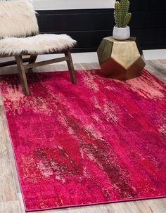 a bright pink rug with an abstract design