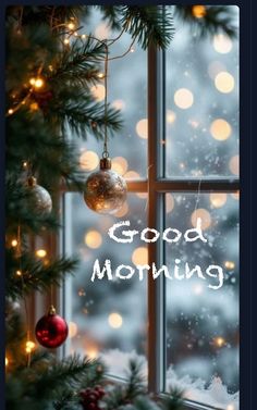 the words good morning are written on a window sill next to a christmas tree