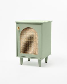 a small green cabinet with a rattan door and handle on the front, against a white background