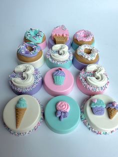 there are many cupcakes with different toppings on the top one is pink, blue and white